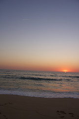 Naklejka na ściany i meble This image shows a sunset at the beach