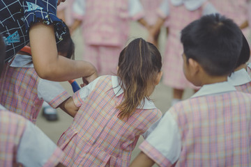 Young Kids exercise with hoola hoop in the morning.