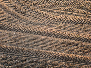 Spring arable land. Field and beautiful patterns from the tractor. View from above.
