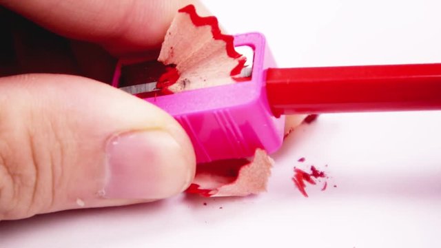 Red sharpener and red wooden color pencil with some oddments
