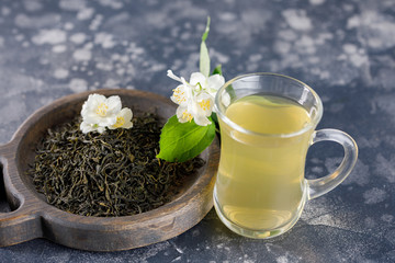 Refreshing drink in a glass cup. Green tea with jasmine.