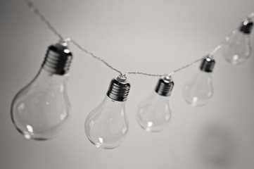 Black and white photo of a garland of incandescent lamps