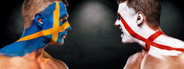 Soccer or football fan with bodyart on face with agression - flags of Sverige, Sweden vs England. Sport Concept with copyspace.