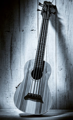 ukulele bass on wooden background