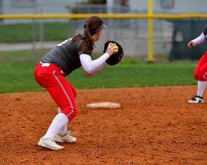 Softball Player Making a Throw for an Out