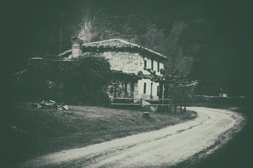 house in the countryside near a road with vintage filter