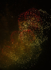 Colored sparks of flying particles on a dark background.