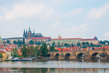 Fototapeta premium View on Vltava river, St.Vitus cathedral and Charles bridge in Prague, Czech Republic