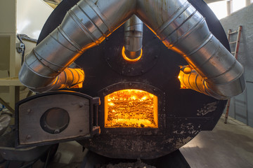 Burning bio pellets fuel in the boiler. Economical, ecologicla fuel.