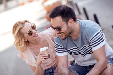 Lovely couple drink coffee outside
