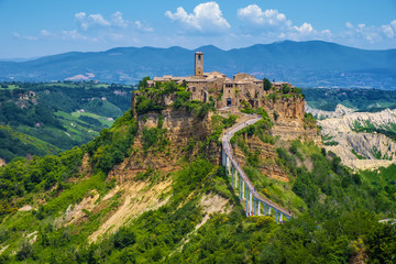 Civita di Bagnoregio, Italy - Panoramic view of historic town of Civita di Bagnoregio with surrounding hills and valleys of Lazio region - obrazy, fototapety, plakaty