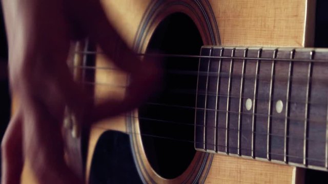 Close up of woman hand playing guitar