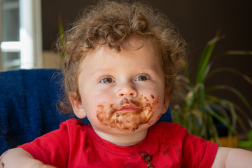 baby is eating a chocolate cake