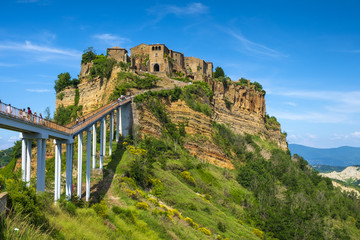 Civita di Bagnoregio, Italy - Panoramic view of historic town of Civita di Bagnoregio with a connecting bridge and surrounding hills and valleys of Lazio region