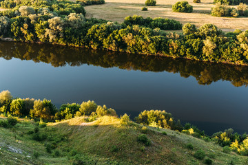 Aerial view at summer forest and big river at sunset, beautiful nature landscape
