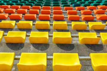 multi-colored rows of plastic seats in the stadium