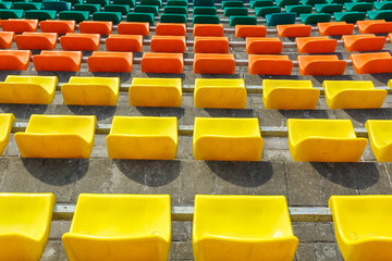 Fototapeta premium multi-colored rows of plastic seats in the stadium