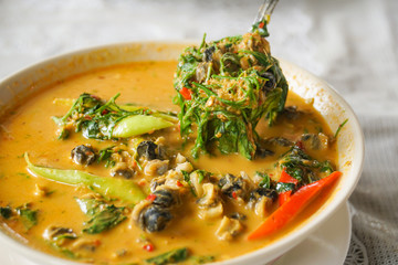 thai traditional spicy red curry with mussel acacia pennata snail