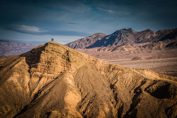 Fototapeta na wymiar Photographers atop massive hill in Death Valley National Park