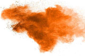 abstract explosion of orange dust on white background. Freeze motion of orange dust splashing.