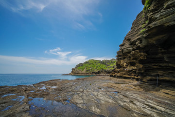 Fototapeta na wymiar Yongmeori Coastal Walk on Jeju Island, South Korea. Rough Geological Formation Made with Erosion