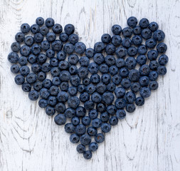 Ripe bluberries on white wooden table
