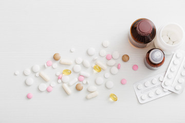 pills on  white wooden table