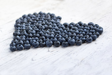 Ripe bluberries on white wooden table