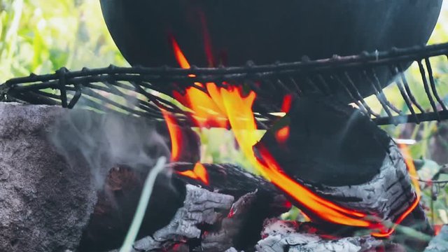 kitchen outdoors.cooking at the stake.metal cauldron on the fire.close-up. 
