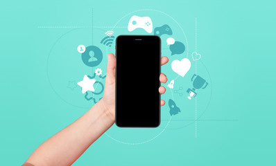 Kid hand holding phone with award and achievement icons on bright blue background. Gamification concept