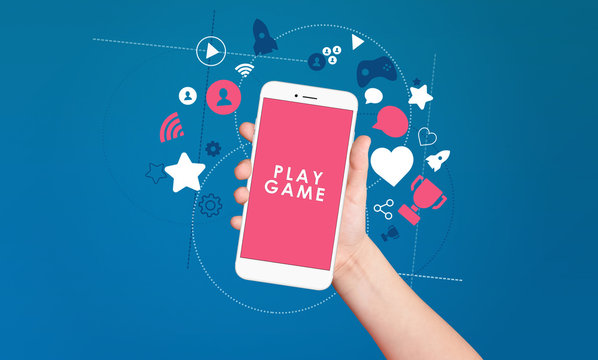 Kid hand holding smartphone with play game text on screen with award and achievement icons on blue background. Gamification concept