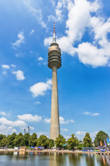 Naklejka premium Munich, Germany - June 09, 2018: A low angle view of the Olympic Tower (Olympiaturm) in the Olympic Park in Munich, Germany.