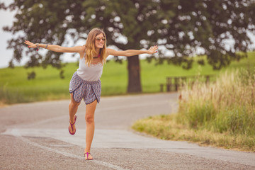 Girl enjoying on a empty suburb road.