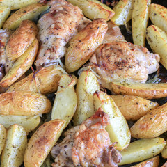 Fried potatoes with chicken with golden crust in the oven