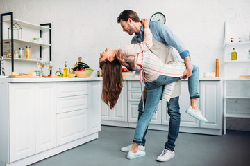 couple dancing tango together in kitchen