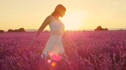Fototapeta na wymiar SLOW MOTION: Sensual woman in beautiful lavender field at sunset