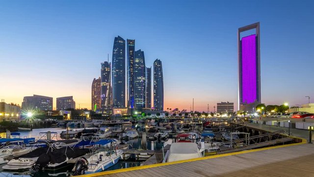 Al Bateen marina Abu Dhabi day to night timelapse with modern skyscrapers on background