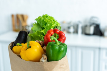close-up view of grocery bag with fresh healthy vegetables