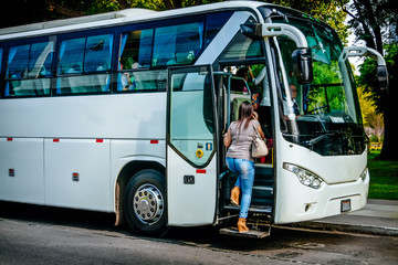 transport, tourism, road trip and people concept - passenger boarding to travel in bus - obrazy, fototapety, plakaty