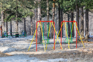 Fototapeta premium Beautiful swing for skating on playground in spring park.