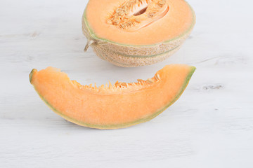 Summer harvest concept Fresh organic healthy fruit Sliced melon on white wooden background Copy space 