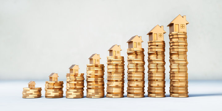 M&uuml;nzstapel mit goldenen Modellh&auml;usern