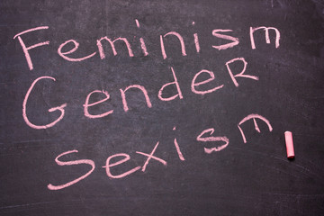 The word gender, feminism, sexism is written chalk