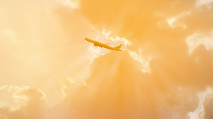 silhouette of airpalne flying in the sunset sky