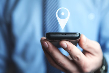 Man holding phone with GPS icon. Concept of mobile navigation