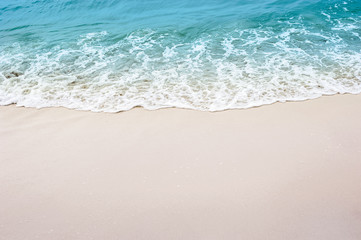Fototapeta na wymiar sand with light blue sea beach
