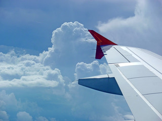 Naklejka na ściany i meble airplane wing and clouds