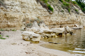 Naklejka premium A pile of stones on the shore river