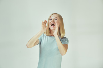 Isolated on pink young casual woman shouting at studio