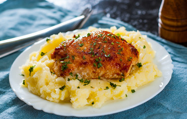 Roasted chicken breast roll stuffed with chicken and pork meat with mashed potatoes in white plate on table